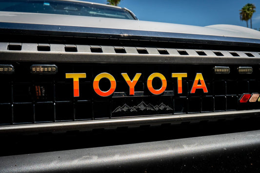 TOYOTA Simple Front Grille Emblem Overlays - 2024+ Land Cruiser - 24LC250-FG2-TOYOTA-WH-24LC250-FG2-TOYOTA-GB-24LC250-FG2-TOYOTA-MB-24LC250-FG2-TOYOTA-BL-24LC250-FG2-TOYOTA-GR- DRIVEN - 2