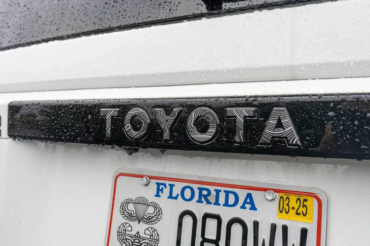"TOYOTA" Topo Rear Tailgate Emblem Overlays - 2024+ Land Cruiser - 24LC250-RT-TOYOTA-TPWH-24LC250-RT-TOYOTA-TPHB-24LC250-RT-TOYOTA-TPVB-24LC250-RT-TOYOTA-TPAG-24LC250-RT-TOYOTA-TPSO-  DRIVEN - 1