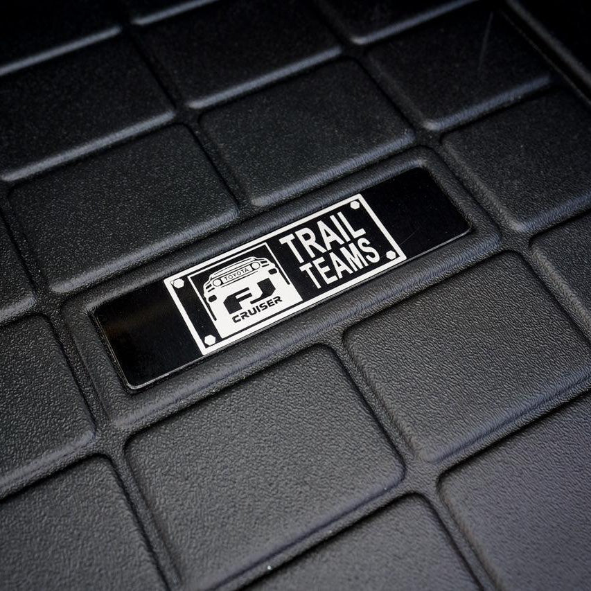Toyota FJ Cruiser Trail Teams Floor Mat Logo Insert (Etched Metal) - Universal - UNIVERSALWTETCH-FJTT1-UNIVERSALWTETCH-FJTT2-  DRIVEN - 1